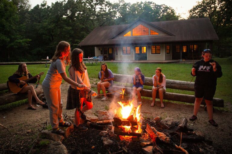 Girls roasting s'mores at camp fire