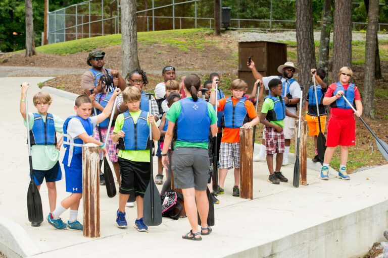 Campers holding canoe paddles