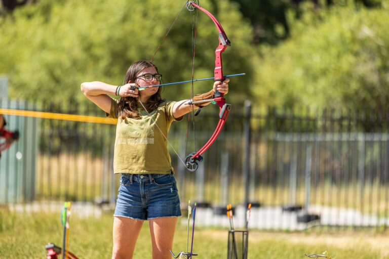 Girl aiming archery bow