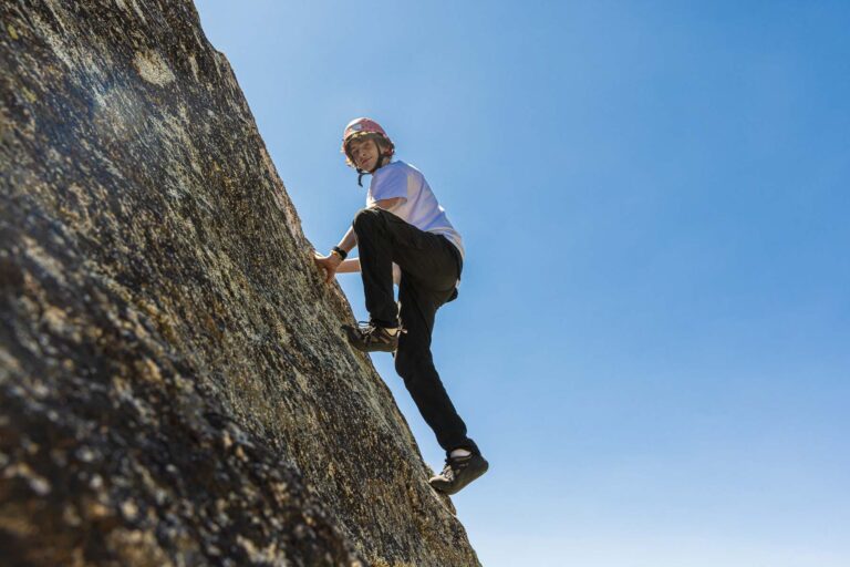 Boy bouldering on rock