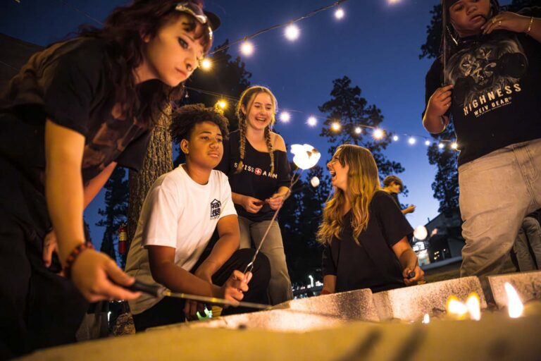 Campers enjoying s'mores at night