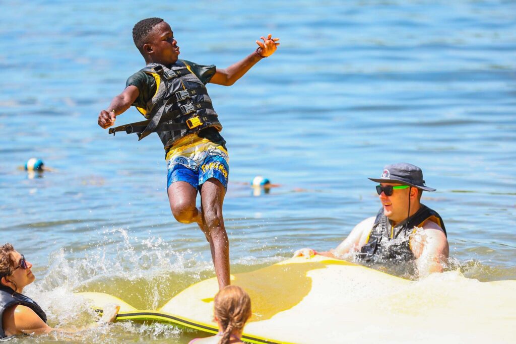 Boy on floating water mat