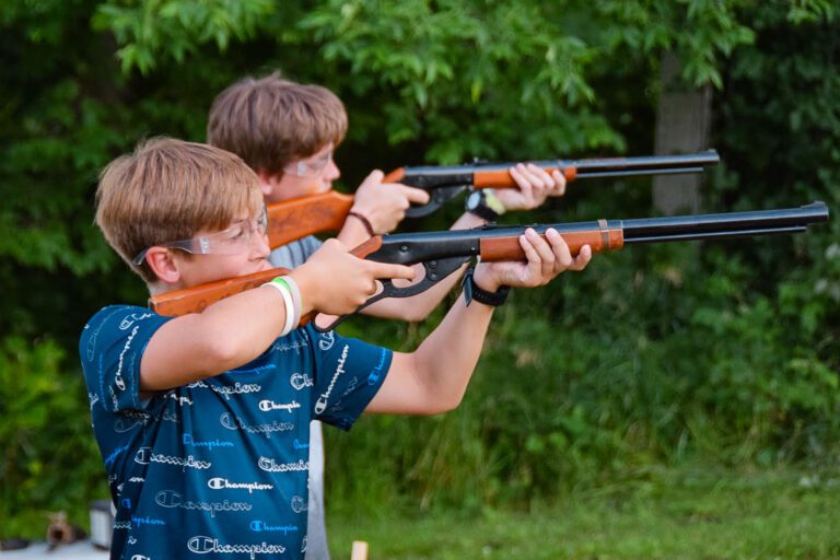 Two boys shooting rifles