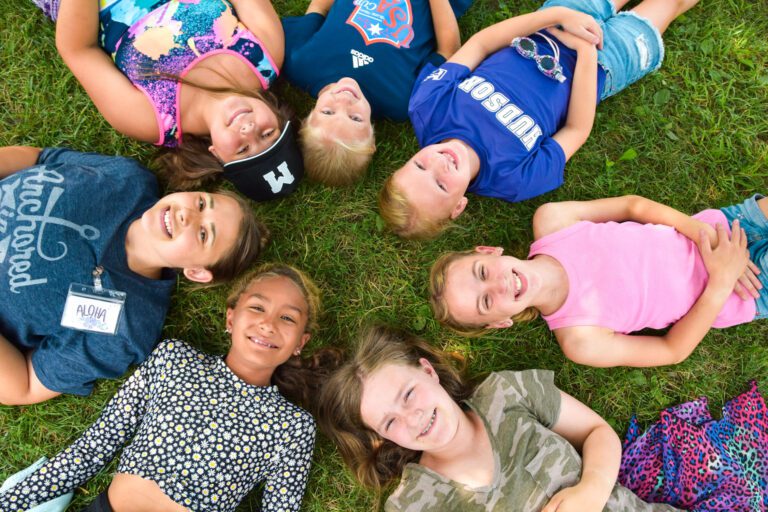 Circle of girl campers smiling
