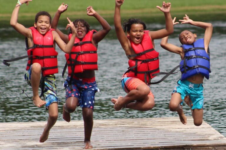 Boys jumping into lake
