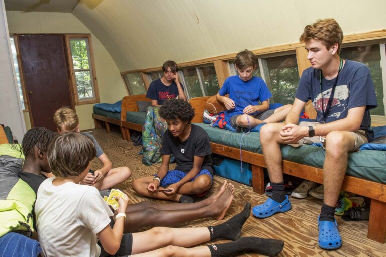 Boys relaxing inside their longhouse