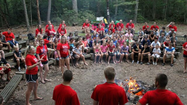 Campers sitting around camp fire