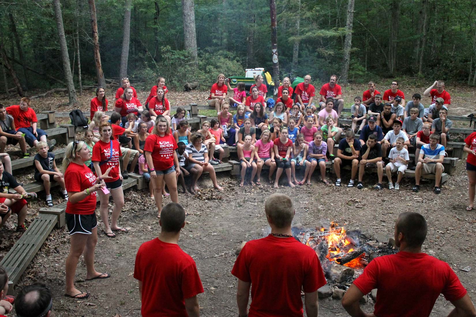 Campers sitting around camp fire