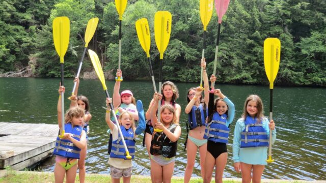Girls holding up oars