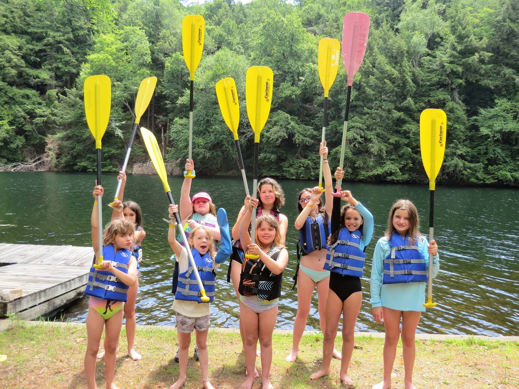 Girls holding up oars