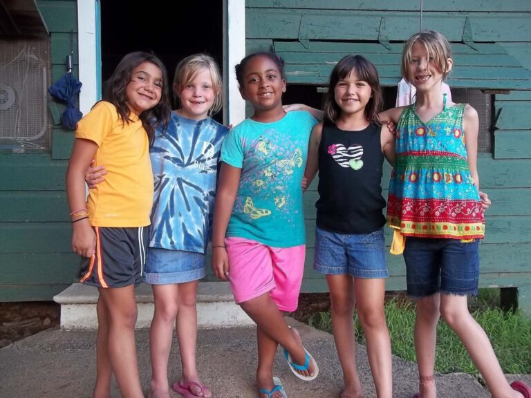 Happy girls outside their cabin