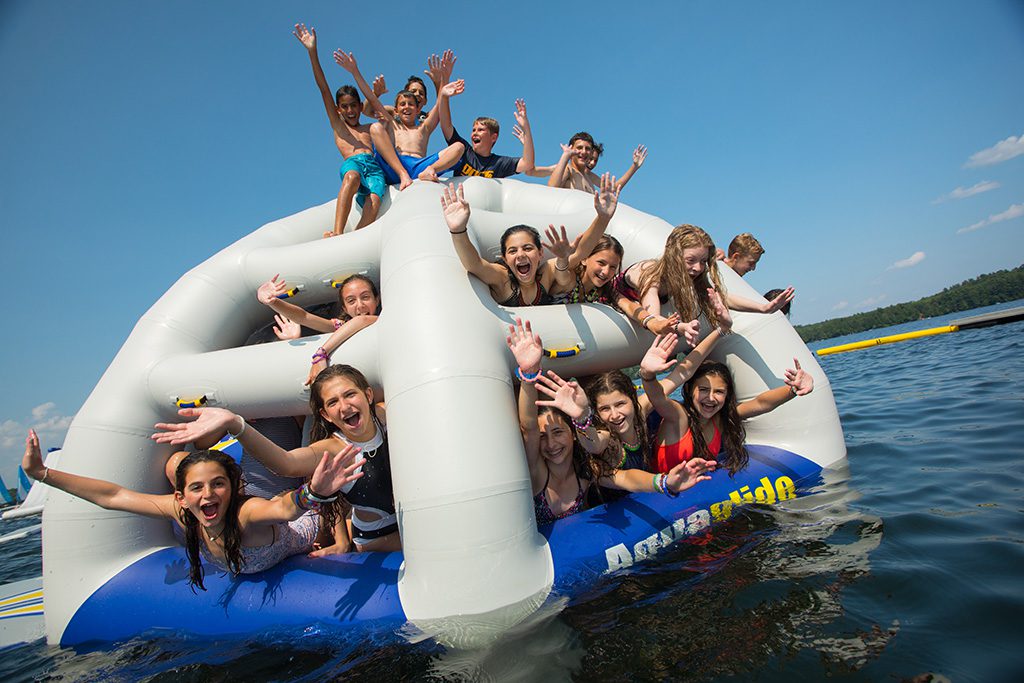 Group of campers on giant water inflatable