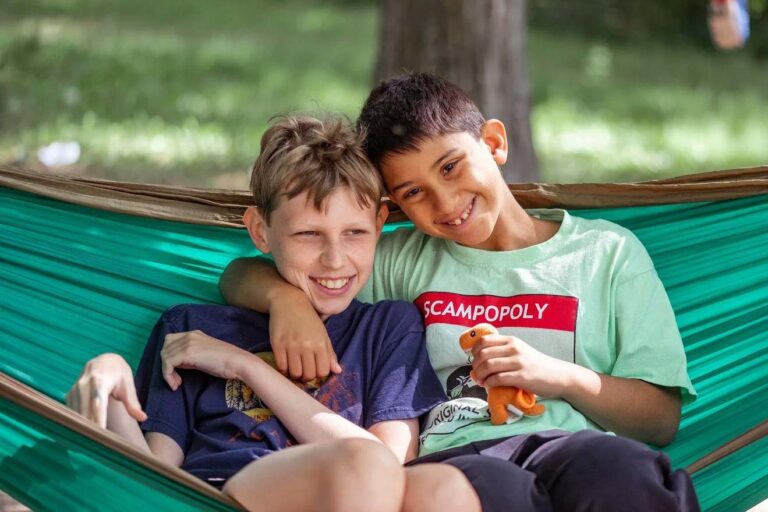 Happy boys sharing a hammock