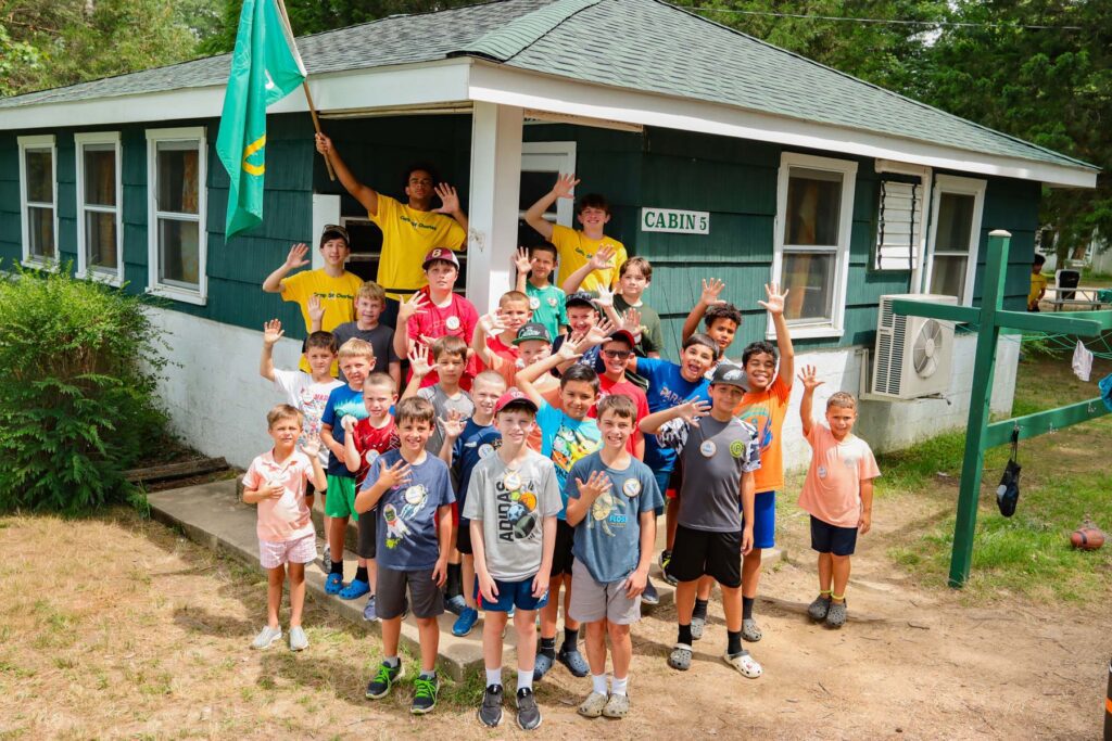 Happy boys outside their cabin