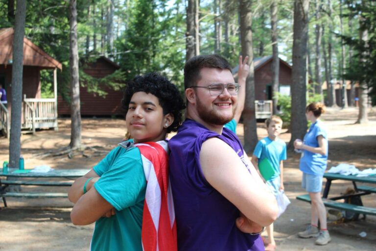 Two campers posing with capes