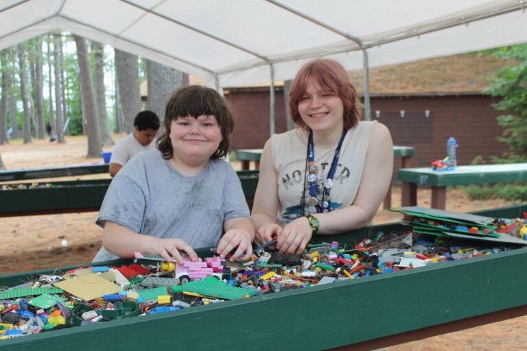 Camper and counselor playing with LEGOs