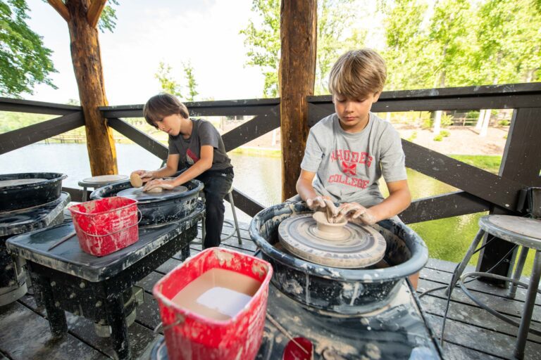 Boys using pottery wheels