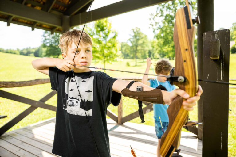 Boy using aiming archery bow