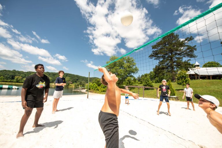 Boys playing beach volleyball