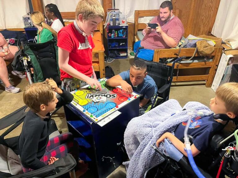 Campers playing a board game in cabin