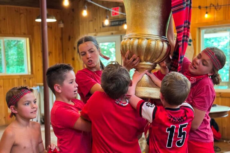 Camper group holding trophy