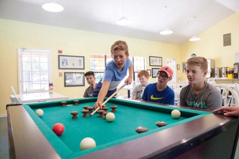 Boys playing pool inside