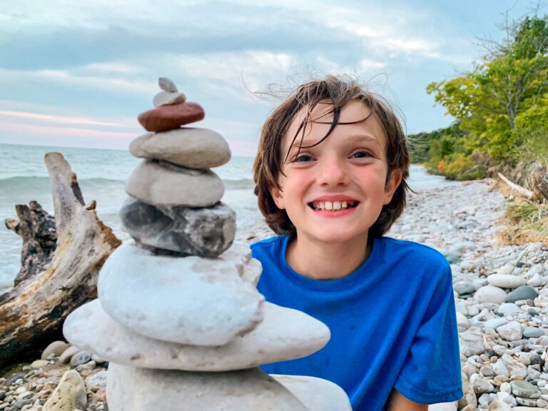 Girl with cairns on beach