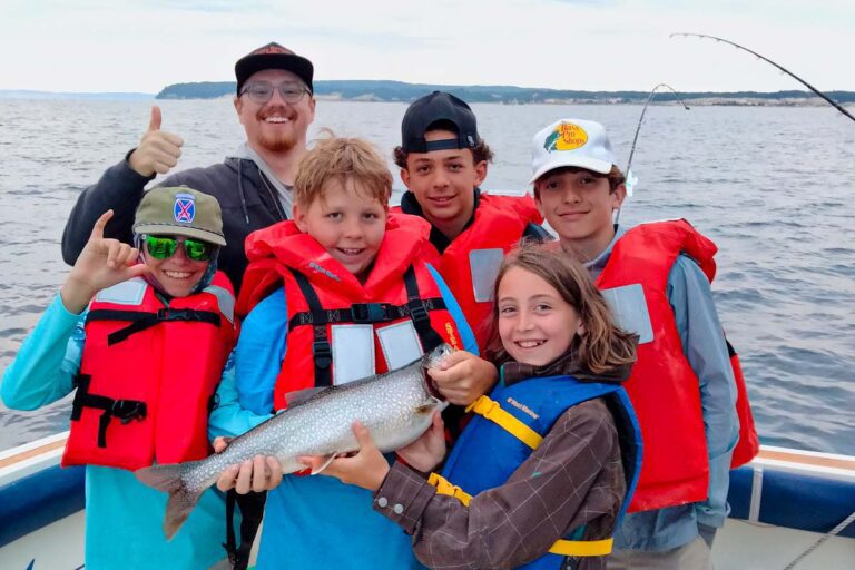 Campers holding a large fish