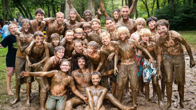 Group of happy muddy boys