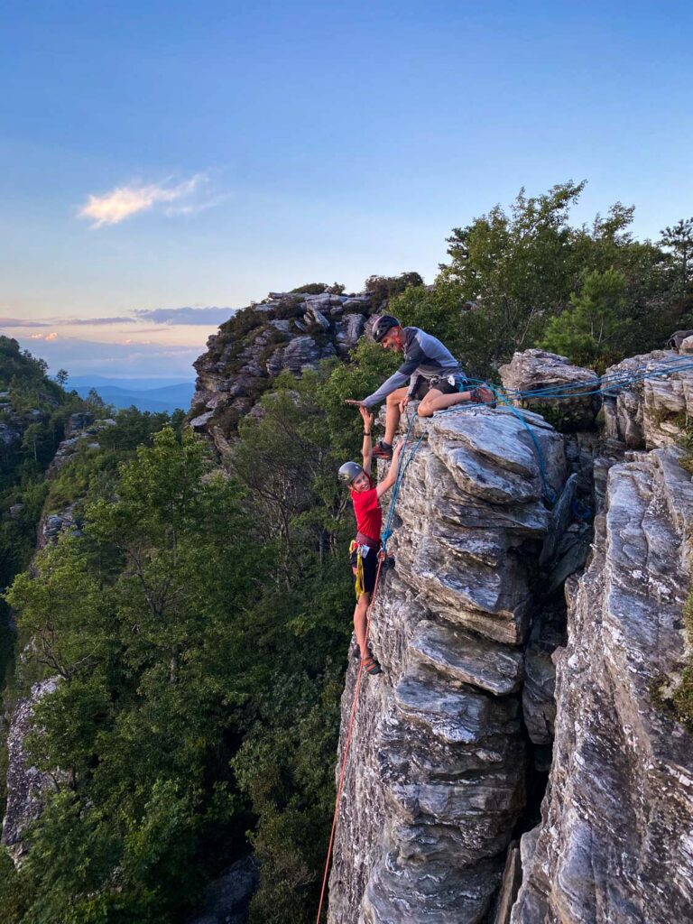 Boy climbing on rock face