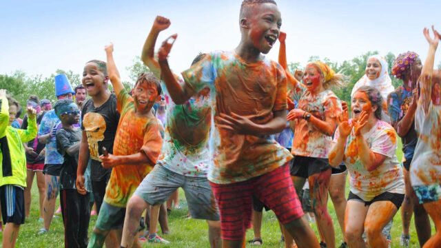 Excited campers covered in paint