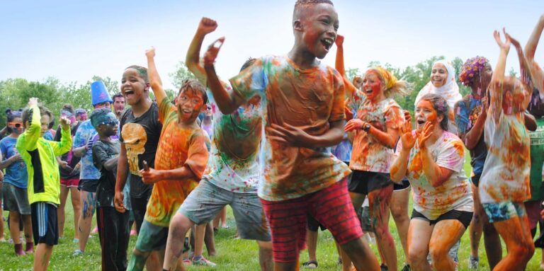 Excited campers covered in paint