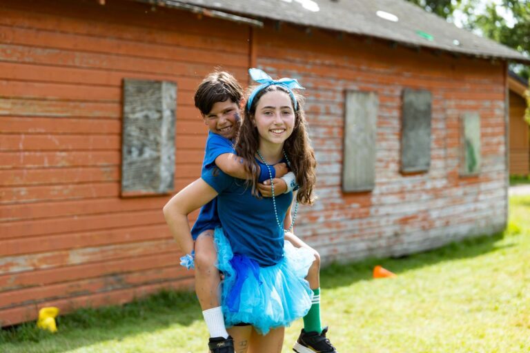 Teen girl holding younger boy