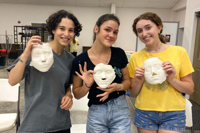 Girls holding artwork