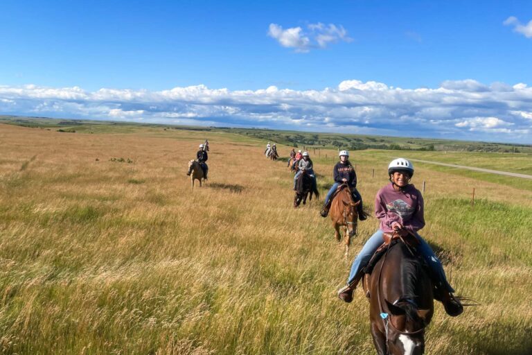 Campers riding horses