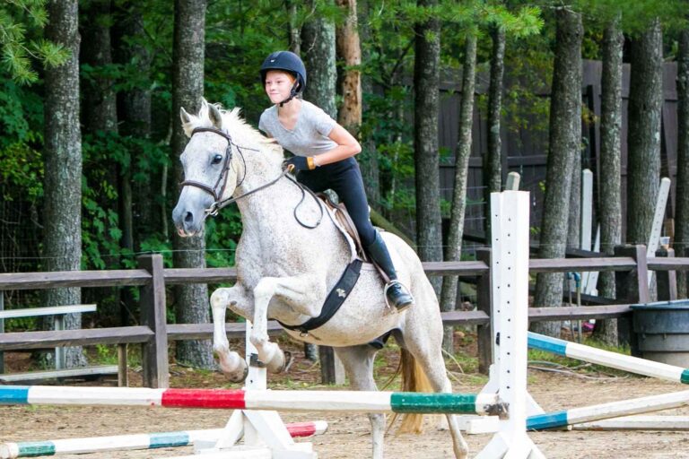 Girl on horseback vaulting