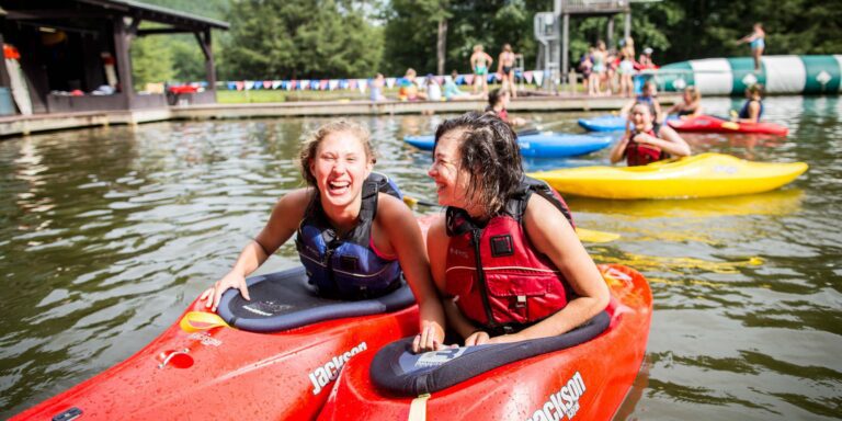 Joyful girls in kayaks