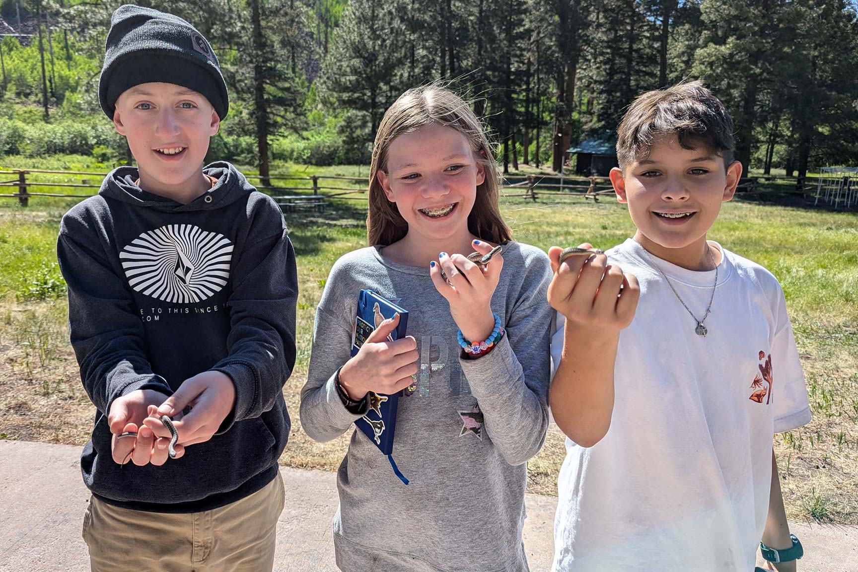 Campers holding snakes