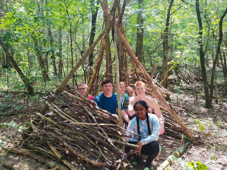 Campers in their bushcraft shelter