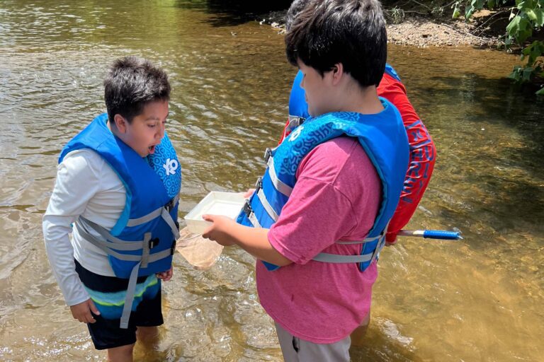 Campers exploring a river