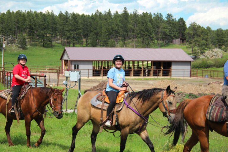 Campers riding horses
