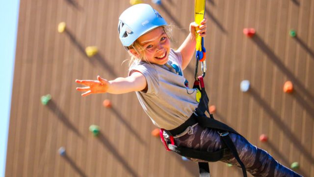 Camper on climbing wall