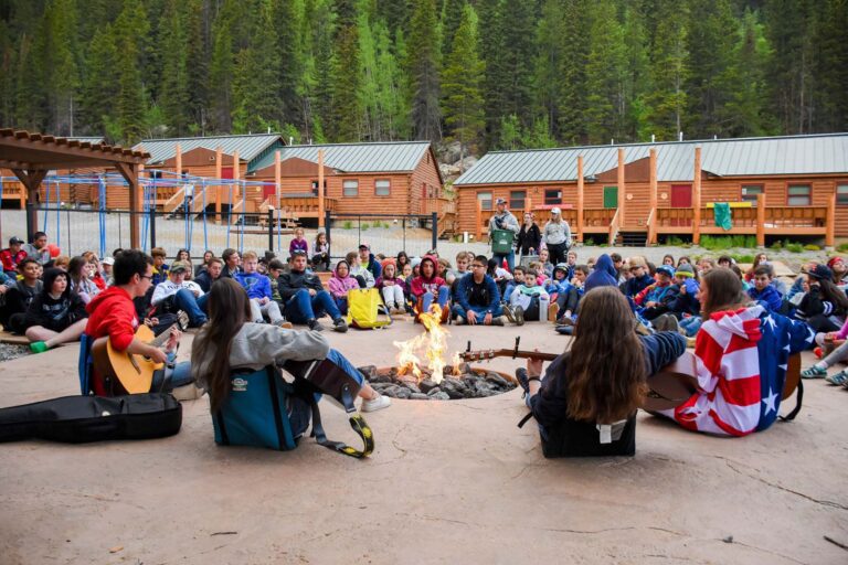 Group sitting around camp fire