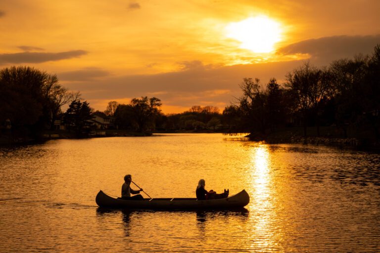 Two teens in a canoe at sunset