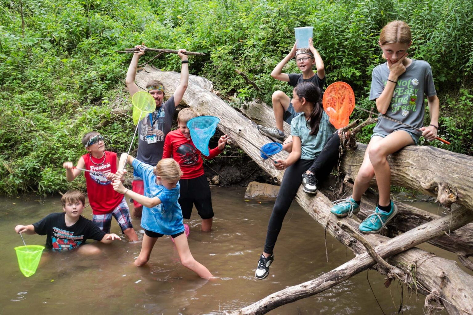 Campers exploring a creek