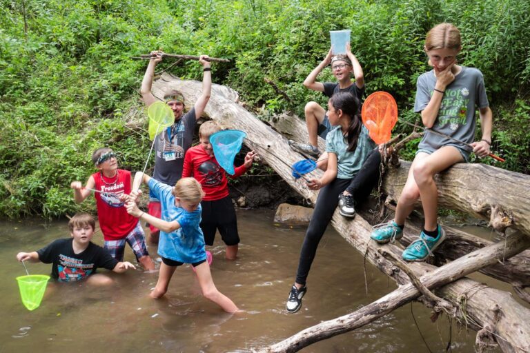 Campers exploring a creek
