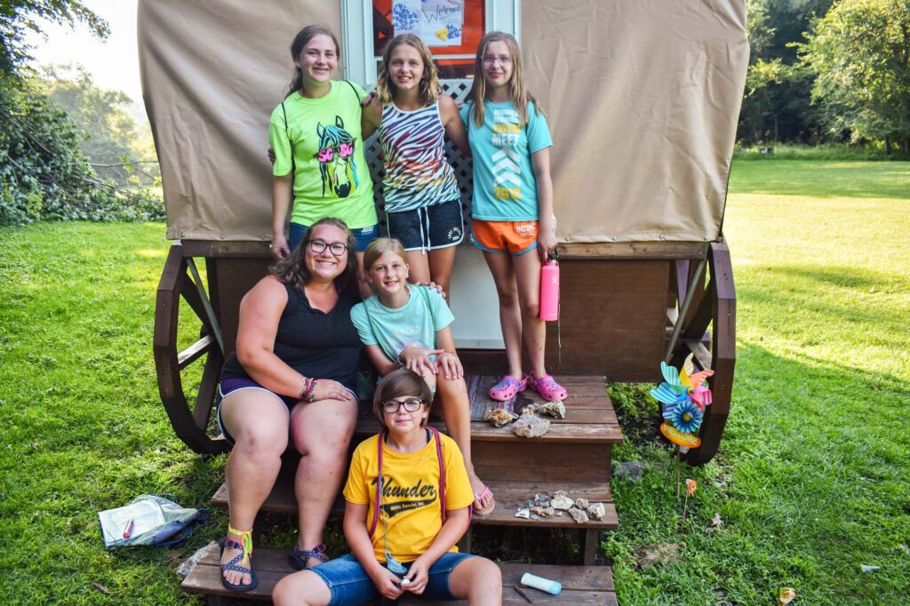 Campers in front of a covered wagon