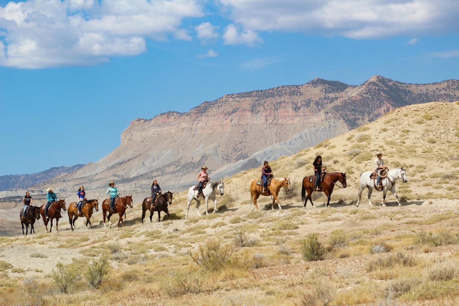 Teens riding horseback in Utah desert