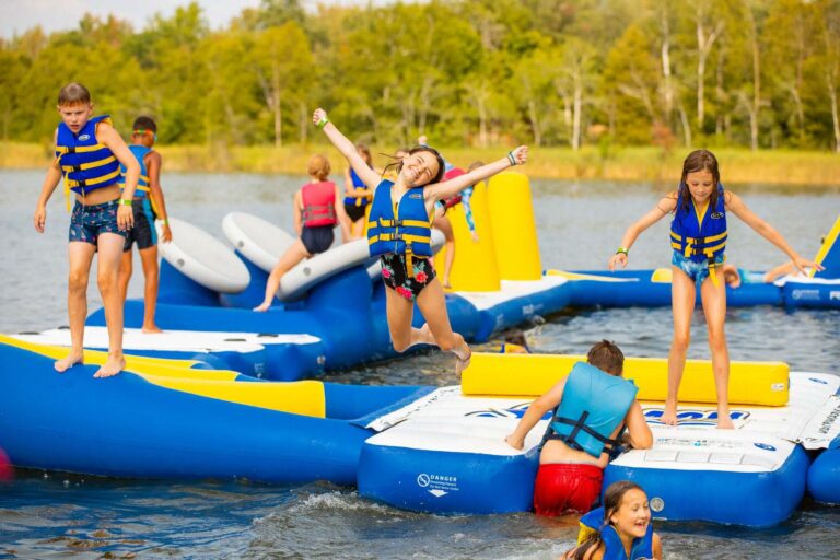 Campers playing on water inflatables