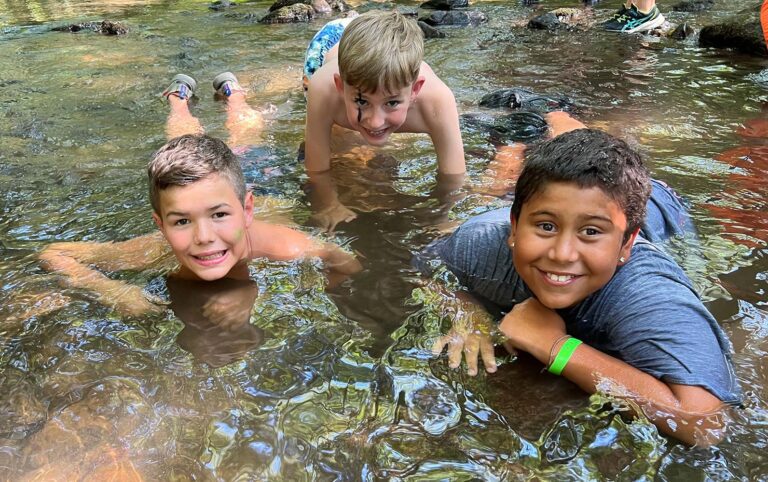 Boys playing in a creek